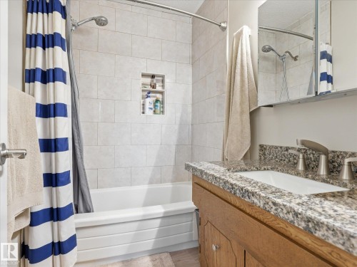 Full-size bathtub with subway tile surround and integrated shower niche - 18627 62A Avenue, Edmonton, AB - Indoor Photo Showing Bathroom