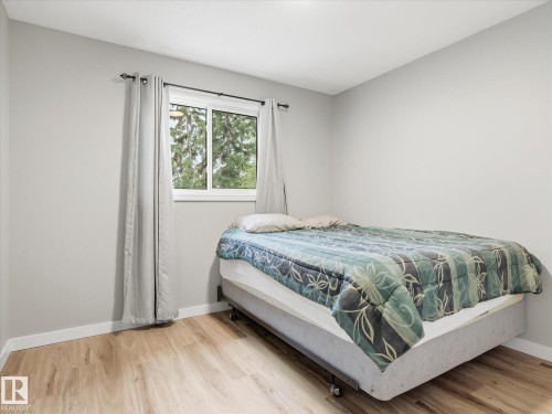 Room featuring wood-finish flooring, white baseboards, and light gray painted walls - 18627 62A Avenue, Edmonton, AB - Indoor Photo Showing Bedroom