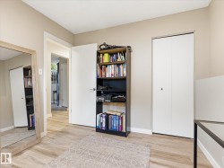 Room featuring light wood-finish flooring, neutral wall tones, and white trim - 