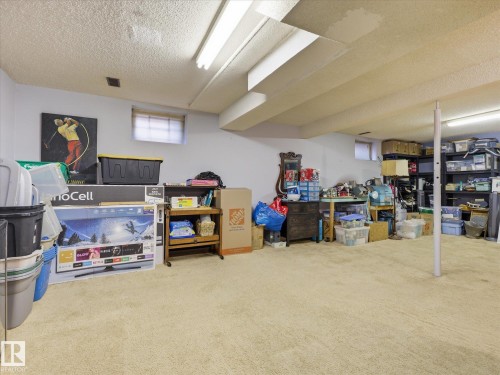 Spacious lower level featuring light-colored carpeting and white painted walls - 18627 62A Avenue, Edmonton, AB - Indoor Photo Showing Basement