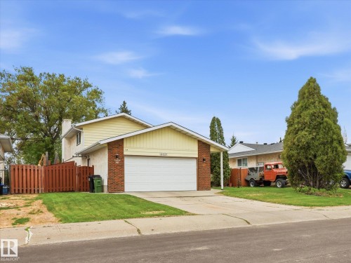 Two-story residence featuring light yellow siding and brick accents - 18627 62A Avenue, Edmonton, AB - Outdoor