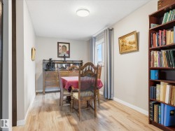 Neutral wall paint, wood-finish flooring, and a bright ceiling light fixture - 