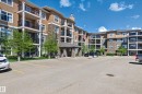 Multi-story residential building featuring diverse siding, stone accents, and private balconies with black railings - 340 6076 Schonsee Way, Edmonton, AB  - Outdoor With Balcony With Facade 