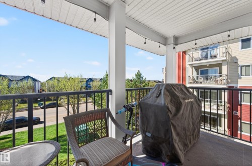 Covered balcony featuring a white vinyl soffit and recessed lighting - 340 6076 Schonsee Way, Edmonton, AB - Outdoor With Balcony With Exterior