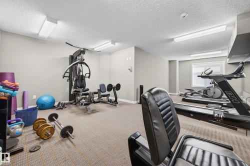 Carpeted exercise room featuring ample space, recessed lighting, and a window for natural light - 340 6076 Schonsee Way, Edmonton, AB - Indoor Photo Showing Gym Room