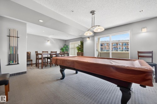 Recreation room featuring a pool table with a fitted cover, recessed lighting, and a built-in cue rack - 340 6076 Schonsee Way, Edmonton, AB - Indoor Photo Showing Other Room