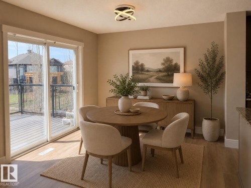 Dining area featuring wood-finish flooring and a contemporary light fixture - 648 178 Street, Edmonton, AB - Indoor Photo Showing Dining Room