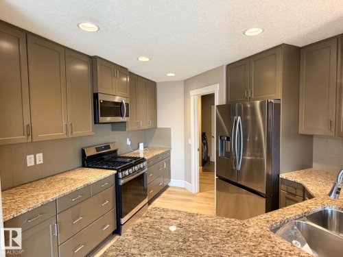 Kitchen featuring extensive cabinetry, stainless steel appliances, granite countertops, and recessed lighting - 648 178 Street, Edmonton, AB - Indoor Photo Showing Kitchen With Double Sink With Upgraded Kitchen
