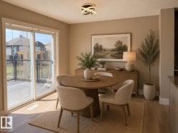 Spacious dining area featuring wood-finish flooring, a contemporary ceiling light fixture, and neutral wall tones - 