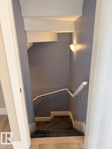 Carpeted staircase with light gray walls and white trim - 648 178 Street, Edmonton, AB - Indoor Photo Showing Other Room