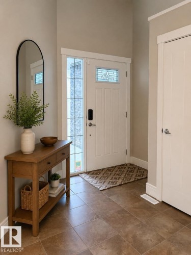 Entryway featuring a paneled door with leaded glass accent, tile flooring, sidelight window, and a built-in closet with a white door - 648 178 Street, Edmonton, AB - Indoor Photo Showing Other Room