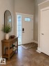 Entryway featuring a paneled door with leaded glass accent, tile flooring, sidelight window, and a built-in closet with a white door - 648 178 Street, Edmonton, AB  - Indoor Photo Showing Other Room 