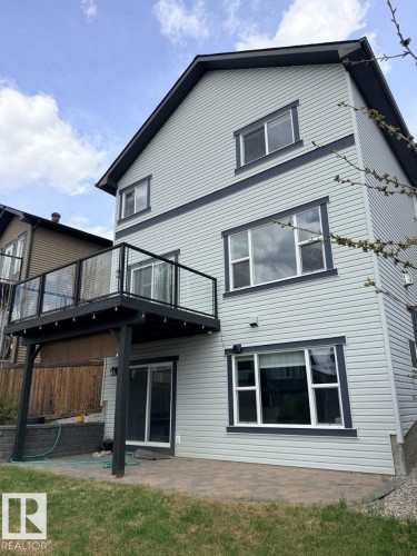 Two-story property featuring light grey horizontal siding with dark trim accents - 648 178 Street, Edmonton, AB - Outdoor With Deck Patio Veranda With Exterior