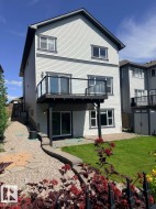 White siding exterior with dark trim accents - 