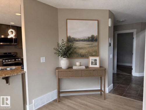 Wood-finish flooring throughout the main area - 648 178 Street, Edmonton, AB - Indoor