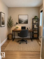 Dedicated room featuring wood-finish flooring, neutral wall tones, and white baseboards - 