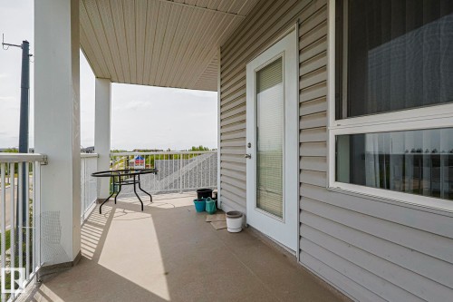 Private balcony featuring a concrete floor, white railing, and a window with horizontal blinds - 314 5340 199 Street, Edmonton, AB - Outdoor With Exterior