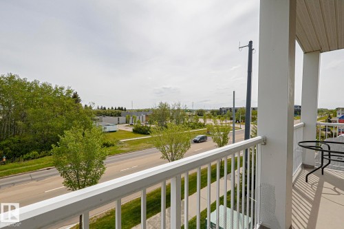 Exterior balcony with white railings and columns, featuring a smooth concrete floor - 314 5340 199 Street, Edmonton, AB - Outdoor