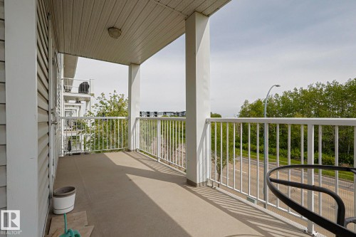 Exterior balcony with a concrete floor, white vertical railing, and a slatted ceiling - 314 5340 199 Street, Edmonton, AB - Outdoor With Exterior