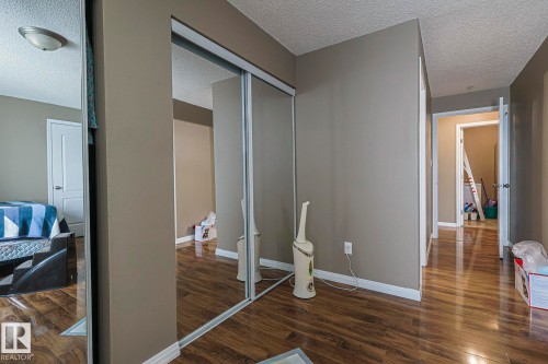Mirrored sliding closet doors - 314 5340 199 Street, Edmonton, AB - Indoor Photo Showing Other Room