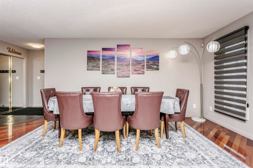 Dining area featuring hardwood flooring, a window with horizontal blinds, and a neutral color palette - 9831 185 Street, Edmonton, AB - Indoor Photo Showing Dining Room