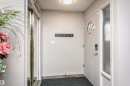 The property features a front door with a decorative transom window and an adjacent frosted glass sidelight - 9831 185 Street, Edmonton, AB  - Indoor Photo Showing Other Room 