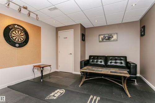 The property features a recreational room with a drop ceiling, recessed lighting, and track lighting - 9831 185 Street, Edmonton, AB - Indoor