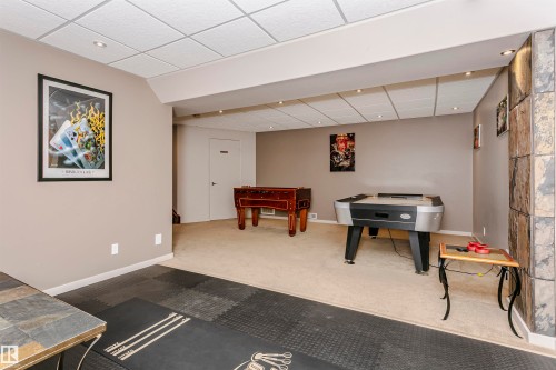 Entertainment room featuring recessed lighting, a drop ceiling, and a distinct floor covering - 9831 185 Street, Edmonton, AB - Indoor