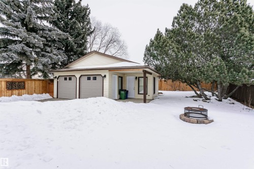 The property features a two-car garage with overhead doors and a covered entrance - 9831 185 Street, Edmonton, AB - Outdoor