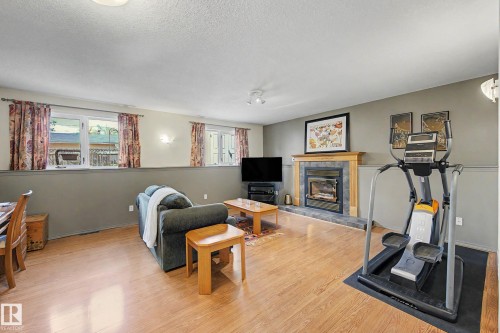 24 Elbow Drive, Devon, AB - Indoor Photo Showing Gym Room With Fireplace