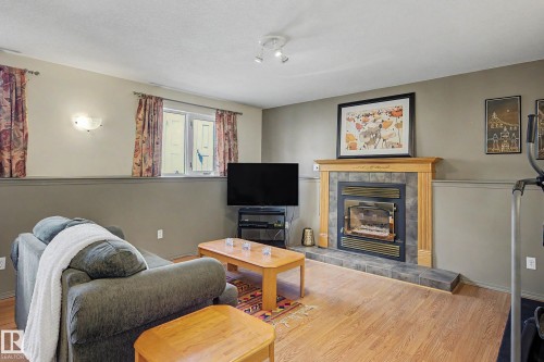 24 Elbow Drive, Devon, AB - Indoor Photo Showing Living Room With Fireplace