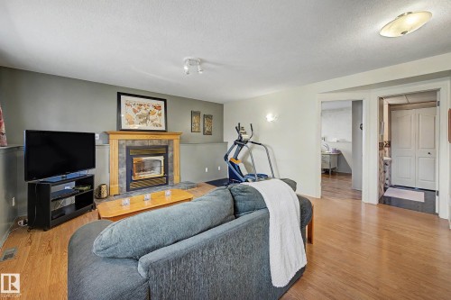 24 Elbow Drive, Devon, AB - Indoor Photo Showing Living Room With Fireplace