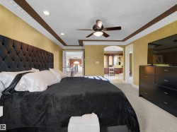 Carpeted room featuring a decorative ceiling fan, recessed lighting, and crown molding - 