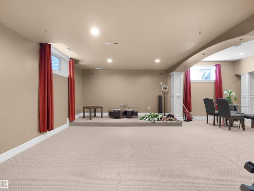 Expansive carpeted area with recessed lighting and neutral wall tones - 1511 69 Street, Edmonton, AB 