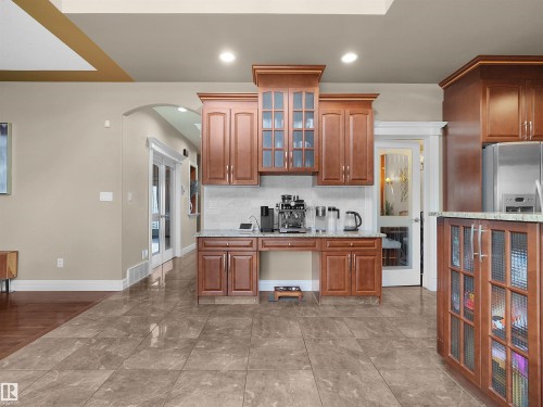 Kitchenette area featuring wood-finish cabinetry, granite countertops, and a tiled backsplash - 1511 69 Street, Edmonton, AB - Indoor Photo Showing Kitchen