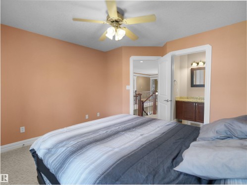 Carpeted room with a ceiling fan light fixture and warm-toned walls - 1511 69 Street, Edmonton, AB - Indoor Photo Showing Bedroom