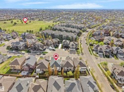 Aerial perspective showcasing a residential neighborhood with varied housing styles and ample green space - 