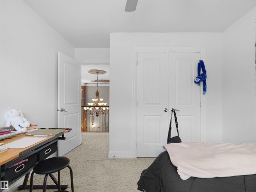 White painted interior room featuring a textured carpet and a ceiling fan - 1511 69 Street, Edmonton, AB - Indoor Photo Showing Bedroom