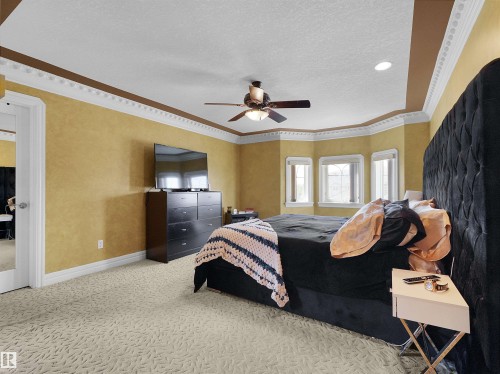 Spacious room featuring textured wall finishes and crown molding - 1511 69 Street, Edmonton, AB - Indoor Photo Showing Bedroom