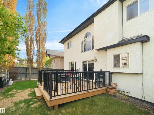 Raised wood deck with black metal railing, featuring a sliding glass door entry to the interior - 1511 69 Street, Edmonton, AB - Outdoor With Exterior