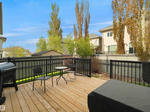Expansive wood deck with black metal railings, offering an outdoor extension of the living space - 1511 69 Street, Edmonton, AB - Outdoor With Deck Patio Veranda With Exterior