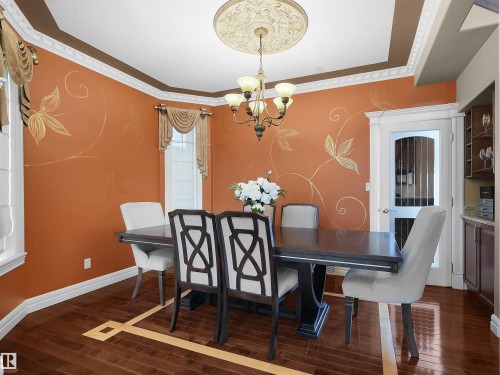 Formal dining space featuring intricate crown molding, a decorative ceiling medallion, and a chandelier - 1511 69 Street, Edmonton, AB - Indoor Photo Showing Dining Room