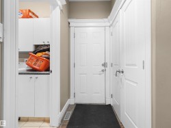 Entryway featuring a paneled door, crown molding, and baseboards - 