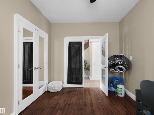 Rich wood-finish flooring extending throughout the space - 1511 69 Street, Edmonton, AB - Indoor Photo Showing Other Room
