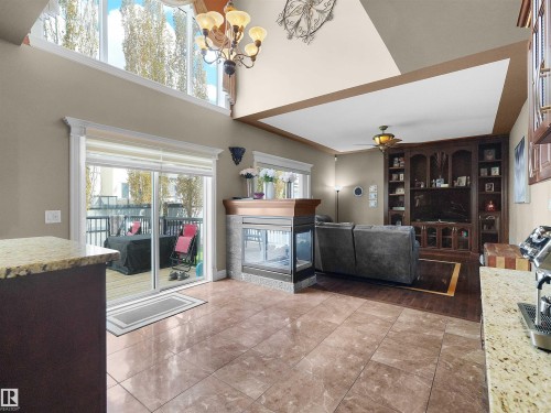 Spacious living area featuring polished tile flooring, a built-in entertainment center, a central fireplace, and a large sliding glass door opening to a private deck - 1511 69 Street, Edmonton, AB - Indoor Photo Showing Other Room With Fireplace