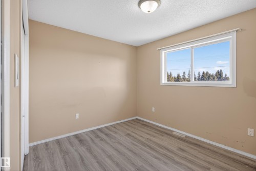 Interior room featuring light brown walls and wood-finish flooring - 5204 55 Ave, Mundare, AB - Indoor Photo Showing Other Room