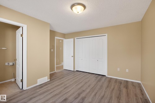 Spacious room featuring wood-finish flooring, neutral-toned walls, and white baseboards - 5204 55 Ave, Mundare, AB - Indoor Photo Showing Other Room