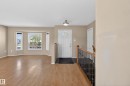 Foyer entry with wood-finish flooring, a white paneled door, and an overhead flush mount light fixture - 5204 55 Ave, Mundare, AB  - Indoor Photo Showing Other Room 