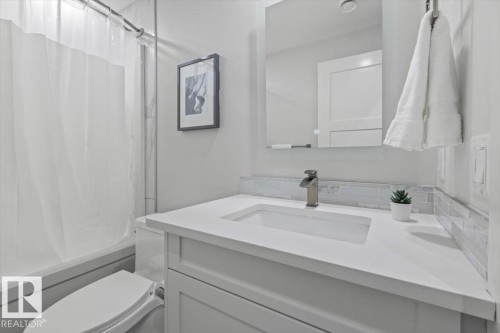 Bathroom vanity featuring a vessel sink, single-handle faucet, and light-toned countertop - 10611 146 Street Nw, Edmonton, AB - Indoor Photo Showing Bathroom
