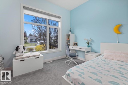Room featuring a large multi-pane window, light blue wall paint, wall-to-wall carpeting, and white baseboards - 10611 146 Street Nw, Edmonton, AB - Indoor Photo Showing Bedroom